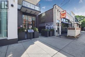 Toronto (Trinity-Bellwoods) condo for rent - A street view of a building with a sign that says "DUNHAM LADY".