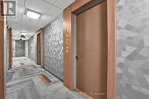 Toronto (Trinity-Bellwoods) condo for rent - A hallway with a wooden door and a glass door with a number 4 on it.