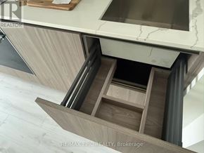 Toronto (Mount Pleasant West) condo for rent - A modern kitchen with a marble countertop and wooden drawers.