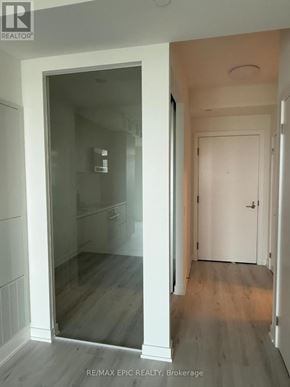 Toronto (Mount Pleasant West) condo for rent - A hallway with a glass door leading to a room.