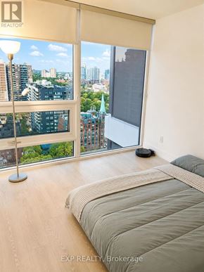 Toronto (Church-Yonge Corridor) condo for rent - A bedroom with a large bed and a view of the city.