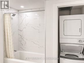 Toronto (Church-Yonge Corridor) condo for rent - A bathroom with a marble tile shower and a built-in washer and dryer.