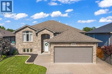 Windsor apartment for rent - A house with a garage and a driveway in front of it.