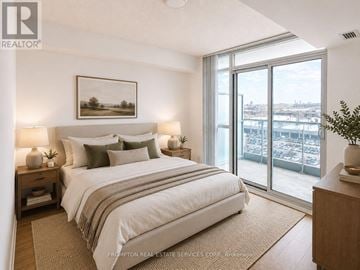 Toronto (Bayview Village) condo for rent - A bedroom with a large bed and a view of the city.
