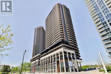 Toronto (Bayview Village) condo for rent - A tall building with a curved facade stands in front of two other buildings.