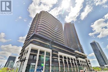 Toronto (Bayview Village) condo for rent - A tall building with a sign that reads "REAL ESTATE SERVICE CORP" in front of it.