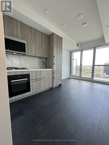 Toronto (Bayview Village) condo for rent - A kitchen with a stove top oven and a microwave.
