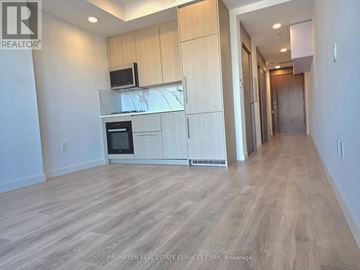 Toronto (Bayview Village) condo for rent - A kitchen with wooden floors and cabinets.