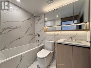 Toronto (Bayview Village) condo for rent - A bathroom with a marble wall and a large mirror.