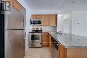 Mississauga (Creditview) condo for rent - A kitchen with a refrigerator, oven, microwave, and sink.
