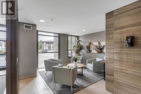 Burlington (Uptown) condo for rent - A modern waiting area with a flat screen TV and comfortable seating.