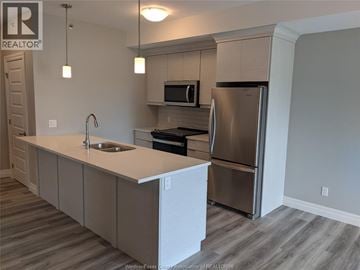 Lakeshore condo for rent - A kitchen with a sink, stove, and refrigerator.