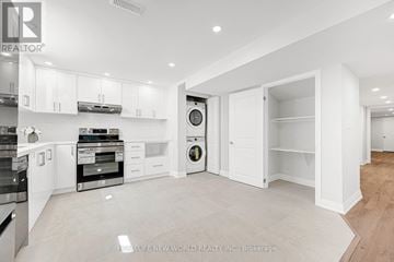 Aurora apartment for rent - A modern kitchen with white cabinets and appliances.