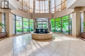 Toronto (Willowdale East) condo for rent - A large, open living room with a central island and a view of the outdoors through the windows.