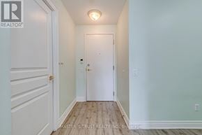Toronto (Willowdale East) condo for rent - A hallway with a white door and a white wall.