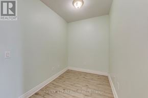 Toronto (Willowdale East) condo for rent - A white room with wood flooring and a light on the ceiling.