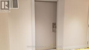 Toronto (Waterfront Communities) condo for rent - A white door with a handle and a lock is in a white room.