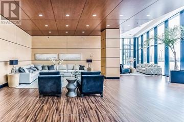 Vaughan (Concord) condo for rent - A living room with a white sofa and a wooden floor.