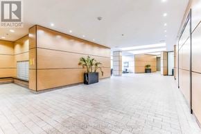 Vaughan (Concord) condo for rent - A spacious hallway with a tiled floor and a plant in a black planter.