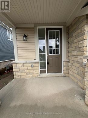Loyalist (Bath) apartment for rent - A brown door with a glass window is on a stone wall.