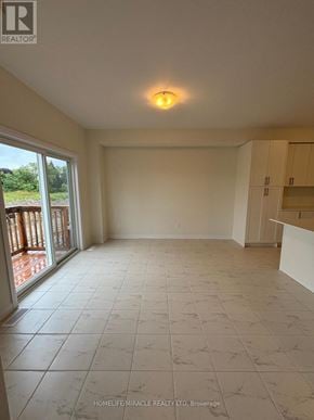 Loyalist (Bath) apartment for rent - A spacious room with tiled flooring and a sliding glass door leading to a balcony.