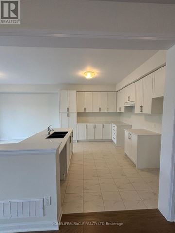 Loyalist (Bath) apartment for rent - A kitchen with white cabinets and a countertop.