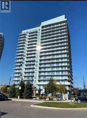 Mississauga condo for rent - A tall building with many windows is the main focus of the image.
