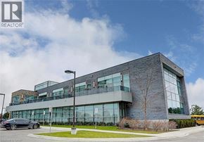 Mississauga condo for rent - A modern building with a glass facade and a tree in front.