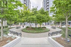 Markham (Commerce Valley) condo for rent - A park with a circular flower bed in the center and benches around it.