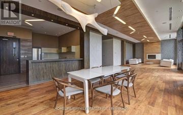Markham (Commerce Valley) condo for rent - A dining room with a white table and chairs.