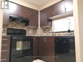 Toronto (New Toronto) condo for rent - A kitchen with dark cabinets and black appliances.