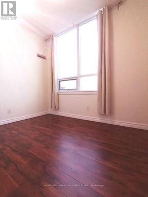 Toronto (New Toronto) condo for rent - A room with wooden floors and a window.