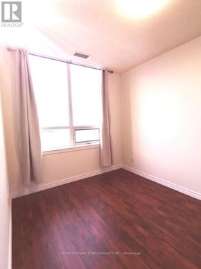 Toronto (New Toronto) condo for rent - A room with a window and a wooden floor.