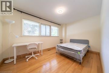 Hamilton apartment for rent - A bedroom with a bed, desk, and chair.