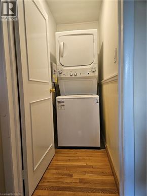 Hamilton apartment for rent - A white dishwasher is in a narrow hallway.