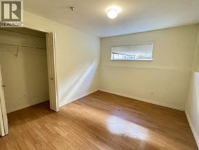 Vancouver apartment for rent - A room with a wooden floor and a window with blinds.