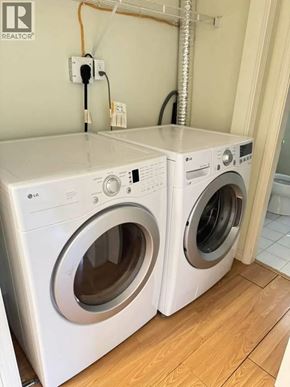 Vancouver apartment for rent - Two white front load washing machines in a laundry room.