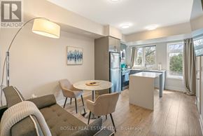 Niagara Falls (Arad/Fallsview) townhouse for rent - A modern living room with a dining table and chairs.