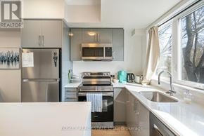 Niagara Falls (Arad/Fallsview) townhouse for rent - A modern kitchen with stainless steel appliances and a large window.