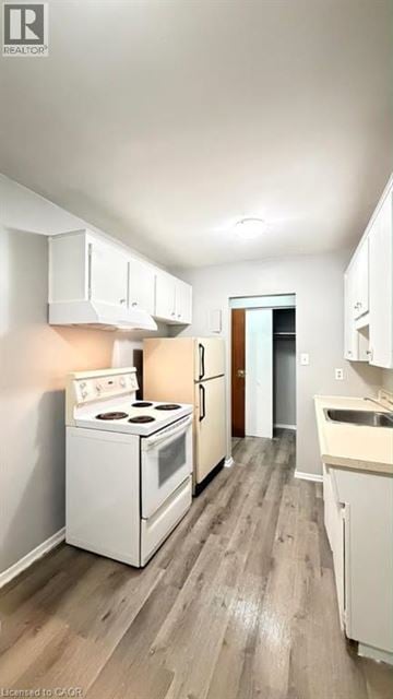 Guelph apartment for rent - A white stove and oven in a kitchen with wooden floors.