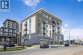 Waterdown condo for rent - A modern apartment building with cars parked in front.