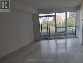 Toronto (Mimico) condo for rent - A room with a view of the city through large windows.