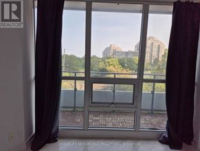 Toronto (Mimico) condo for rent - A view of a balcony with a glass door and a cityscape in the background.