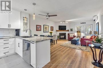Collingwood condo for rent - A modern kitchen with white cabinets and a wooden floor.