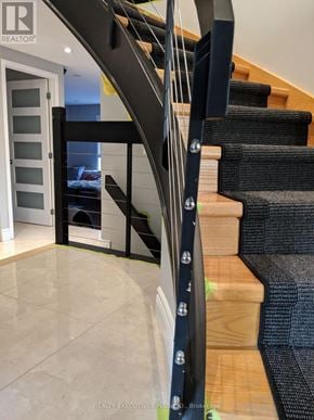 Ottawa apartment for rent - A staircase with a black metal railing and wooden steps.