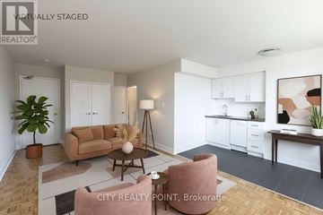 Toronto (Annex) condo for rent - A living room with a brown couch and a coffee table.