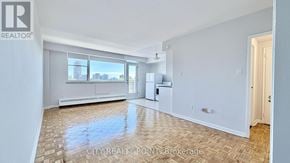 Toronto (Annex) condo for rent - A kitchen with white cabinets and a wooden floor.