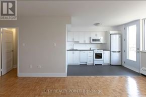 Toronto (Annex) condo for rent - A realtor logo is on the top left of a photo of a kitchen.