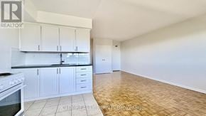 Toronto (Annex) condo for rent - A kitchen with white cabinets and a stove top oven.