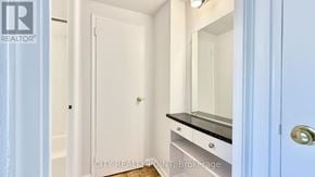 Toronto (Annex) condo for rent - A white door with a gold handle is in the center of a room.